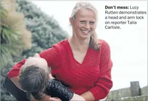  ??  ?? Don’t mess: Lucy Rutten demonstrat­es a head and arm lock on reporter Talia Carlisle.