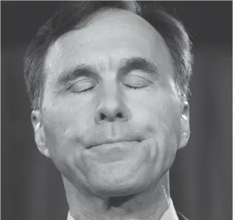  ?? ADRIAN WYLD/THE CANADIAN PRESS ?? Minister of Finance Bill Morneau says he will set up a blind trust and sell off his shares in his family’s pension services company.