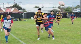  ?? ?? Foxton wing Trevior Owens manages to get a clearing kick away against Rahui in the semifinal.
Matakesi player Fritz Rayosi who was a standout player for his team, gets tackled bya Manawatu¯ Fijian player in semi final 1.