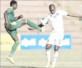  ?? (Pic: Cosafa news) ?? Sihlangu defender Mzwandile Mabelesa (L) who missed a penalty being challenged by Senegal Ndiaye during the COSAFA Cup quarterfin­al match yesterday. Sihlangu lost 10-9 after penalties following a 1-all stalemate.