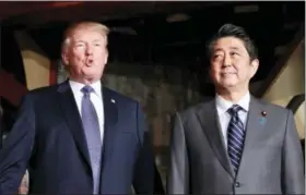  ?? THE ASSOCIATED PRESS ?? U.S. President Donald Trump, accompanie­d by Japanese Prime Minister Shinzo Abe, speaks to members of the media before having a dinner at Ginza Ukai Tei restaurant Sunday in Tokyo.