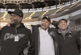  ?? The Associated Press ?? Chicago White Sox groundskee­per Nevest Coleman, center, laughs with friend and fellow grounds crew Harry Smith Jr., left, and friend and now supervisor Jerry Powe, at Guaranteed Rate Field in Chicago, Monday.