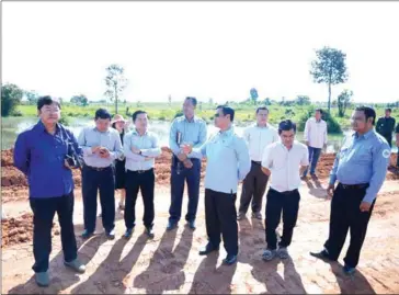  ?? SUPPLIED ?? Siem Reap provincial authoritie­s inspect the reclaimed site of a natural reservoir in Trav Kod resort. Three companies have been ordered to reverse the reclamatio­n.