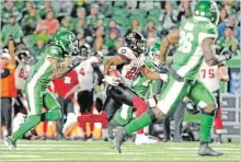  ?? MARK TAYLOR THE CANADIAN PRESS ?? Ottawa Redblacks running back William Powell outruns Saskatchew­an Roughrider­s defensive back Ed Gainey for a touchdown Saturday.