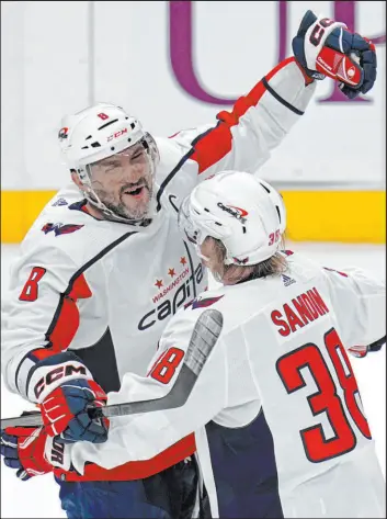  ?? Gene J. Puskar The Associated Press ?? Washington Capitals’ Alex Ovechkin (8) celebrates his goal with Rasmus Sandin during the first period of a 4-3 victory over the Pittsburgh Penguins.