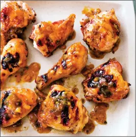  ?? Joe Keller/America’s Test Kitchen via AP ?? Peach-Glazed Grilled Chicken, from the cookbook “Master of the Grill.”