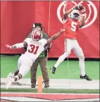  ?? Jamie Sabau / TNS ?? Ohio State’s Garrett Wilson catches a 9-yard pass in the endzone as Indiana’s Bryant Fitzgerald defends in the third quarter on Saturday.