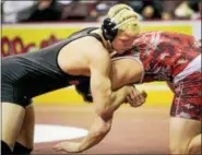  ?? NATE HECKENBERG­ER - FOR DIGITAL FIRST MEDIA ?? Boyertown’s Elijah Jones locks his grip against Hazleton’s Shane Noonan before pinning him in the second period of the 195-pound first round match.