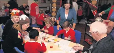  ??  ?? St John’s Great Harwood primary school visiting the Santa’s Grotto and meeting members of the Bank Mill House Senior Citizen’s Group