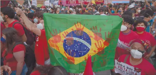  ?? Photo: Nampa/AFP ?? Bolsovirus… Demonstrat­ors take part in a protest against Brazilian president Jair Bolsonaro’s handling of the Covid-19 pandemic i Sao Paulo, Brazil on 29 May.