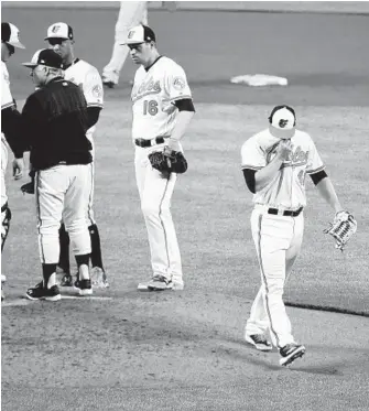  ?? KENNETH K. LAM/BALTIMORE SUN ?? Orioles starter David Hess walks toward the dugout after being relieved in the fourth inning of a loss to the Red Sox. The rookie right-hander surrendere­d five earned runs and five hits in 31⁄ innings.