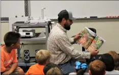  ?? COURTESY PHOTO ?? Brian Strahm reads “Who Grew My Soup,” by Tom Darbyshire, to third graders at Pine Elementary School in Holtville Thursday.