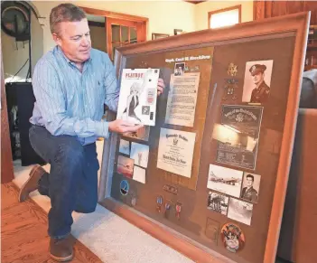  ?? JOHN KLEIN / FOR THE MILWAUKEE JOURNAL SENTINEL ?? Carl Veenendaal shows off his copy of the first Playboy from 1953 as well as artifacts from his uncle, who bought the magazine with Marilyn Monroe on the cover. Only 54,000 copies were sold. In 1956, the uncle, Carl Krecklow, died in a military...