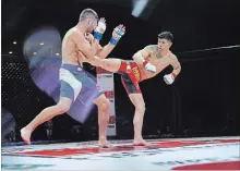  ?? PATRICK DUFFY, BTC/SPECIAL TO THE EXAMINER ?? Jason Saggo fends off a kick from Adam Assenza in their BTC lightweigh­t title match during BTC 4 Vendetta at the Memorial Centre on Saturday.