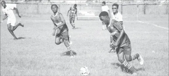  ?? ?? Part of the semi-final action in the ExxonMobil U14 Football Championsh­ip between Charlestow­n (yellow) and West Ruimveldt.