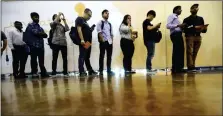  ?? LM OTERO — THE ASSOCIATED PRESS ?? Job seekers line up to speak to recruiters at an Amazon job fair in Dallas.