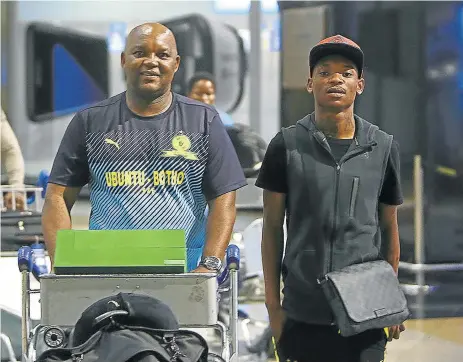  ?? Picture: SIZWE NDINGANE ?? BEST OF THE BEST: Mamelodi Sundowns head coach Pitso Mosimane, left, and midfield star Khama Billiat arrive at OR Tambo Internatio­nal Airport yesterday from the 2016 Caf Awards in Abuja, Nigeria. Mosimane won coach of the year while Billiat was named...