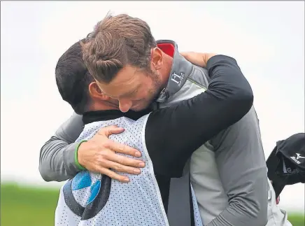  ??  ?? TEAMWORK: Chris Wood hugs his Scottish bagman Mark Crane after the caddie’s calm words proved to be wise advice
