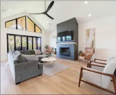  ?? SUBMITTED PHOTO ?? This great room, featuring a vaulted ceiling, wood flooring, plenty of natural light and a floor-to-ceiling fireplace with a wood mantel shelf, is in a home designed and built by Hines Homes.