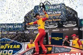  ?? MATT KELLEY/ASSOCIATED PRESS ?? Joey Logano celebrates in Victory Lane after winning the Goodyear 400. To do so, he had to bump leader William Byron into the wall on the next-to-last lap of the race.