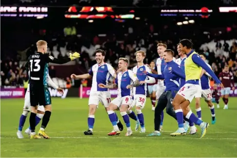  ?? (PA) ?? B lackburn players celebrate after knocking West Ham out of the Carabao Cup