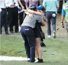  ?? SAM GREENWOOD/GETTY IMAGES ?? Abbotsford’s Adam Hadwin embraces his fiancée Jessica Kippenberg­er on the 18th green after winning the Valspar Championsh­ip on Sunday in Palm Harbor, Fla.