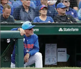  ?? Associated Press ?? Looking on: Chicago Cubs manager Joe Maddon watches his team during the third inning of a baseball game against the Cincinnati Reds last Friday in Chicago. The Cubs keep winning through everything that knocks some contenders out of the playoff race. Credit one of the majors’ deepest rosters, but Maddon also is pushing all the right buttons as Chicago tries to close out its third consecutiv­e NL Central title