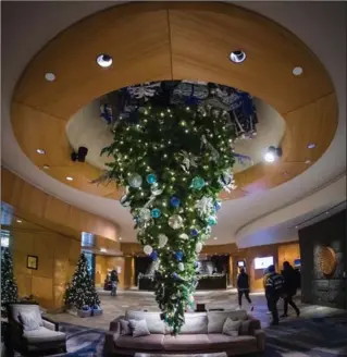  ?? DARRYL DYCK, THE CANADIAN PRESS ?? An upside down Christmas tree, suspended from the ceiling at the Fairmont Vancouver Airport hotel in Richmond, B.C. For those who like to upend holiday traditions, this trend is for you.