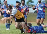  ?? PHOTO: CHRIS ISON ?? TACKLING TEST: The dogged Toowoomba defence tries to wrap up Rockhampto­n’s Nathan Young at the 47th Battalion Trophy Carnival at Yeppoon.