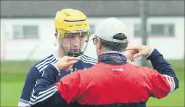  ?? ?? Intense concentrat­ion from Fionn Fitzgerald to words of wisdom from Derek Casey before the 2021 U15 East Cork semi-final.