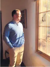  ?? ELAINE D. BRISEÑO/JOURNAL ?? Jonathan Hayes looks out a window at the Randall Davey Audubon Center & Sanctuary in Santa Fe. The building was once the stables for the land’s former owner.