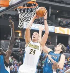  ?? John Leyba, Denver Post file ?? Nuggets center Mason Plumlee scores against the Minnesota Timberwolv­es last season.