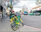  ?? Eduardo Contreras San Diego Union-Tribune ?? SAN DIEGO’S Little Italy Assn. called for a temporary ban on “dockless” bicycles. The city declined.