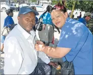  ??  ?? SHOWING PINK SUPPORT: DA leaders took to the streets of Queenstown last week to hand out pink ribbons for cancer awareness to residents, with, from left Zakile Manzi receiving a ribbon from DA constituen­cy manager Fidelia Malatoe