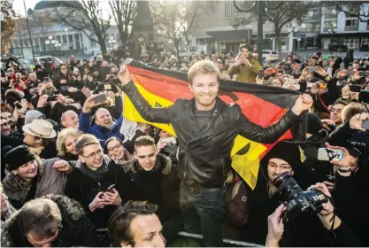  ??  ?? WIESBADEN: F1 Mercedes driver and 2016 World Champion, Nico Rosberg from Germany celebrates with fans in Wiesbaden Germany, yesterday. Rosberg was born in Wiesbaden. — AP