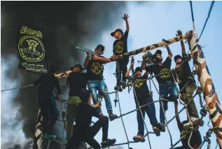  ?? (Atia Mohammed/Flash90) ?? YOUNG PALESTINIA­NS take part in a military-style exercise at a summer camp organized by al-Quds Brigades, the armed wing of the Palestinia­n Islamic Jihad group in Gaza on Saturday.