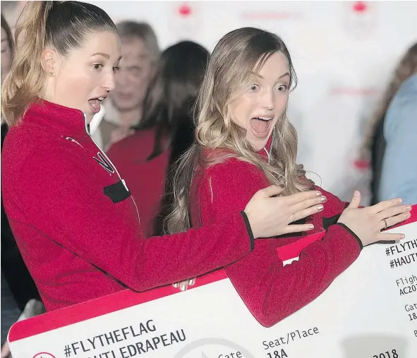  ?? — POSTMEDIA NEWS ?? Chloe Dufour-Lapointe, left, and her sister Justine ham it up for the camera after they where introduced in Montreal on Monday as part of Canada’s freestyle ski team. They will be joined by two other women’s mogul skiers, Andi Naude and Audrey Robichaud.