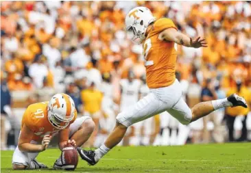  ?? STAFF PHOTO BY ERIN O. SMITH ?? Tennessee’s Joe Doyle, left, holds the ball for Brent Cimaglia as he connects for a field goal against East Tennessee State last season at Neyland Stadium. Doyle is also the Vols’ punter.
