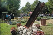  ?? TRENTONIAN FILE PHOTO ?? Hamilton leaders place a memorial wreath at the townshipís 9-11 memorial during a service on the 15th anniversar­y of the terrorist attacks of 2001. In the foreground is a beam from the wreckage of the New York attack.