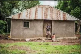  ?? TED KENYA — GIVEDIRECT­LY VIA AP ?? In this April 2017 photo provided by GiveDirect­ly, GiveDirect­ly basic income recipient Irine Ogolla poses in front of her home with her son near Lake Victoria in Kenya.