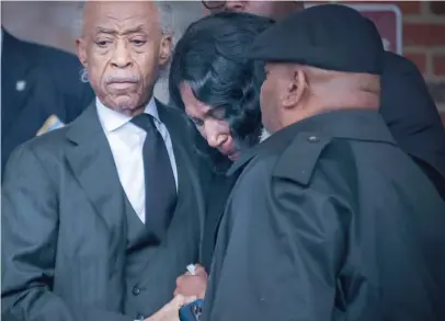  ?? ?? The Rev. Al Sharpton comforts RowVaughn Wells, the mother of Tyre Nichols, on Wednesday after Nichols’ funeral in Memphis.