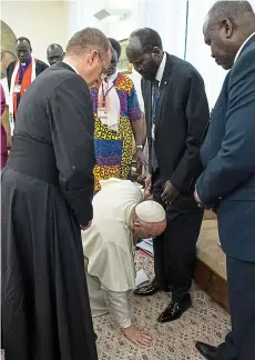  ??  ?? Humble: Francis kisses president Salva Kiir’s feet