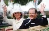  ??  ?? Picture taken on June 25, 2013 in Aachen, western Germany, shows British actor and UNICEF Goodwill Ambassador Roger Moore and his Danish wife Kristina Tholstrup waving from a carriage as they visit the CHIO World Equestrian Festival.