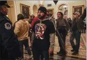  ?? MANUEL BALCE CENETA — THE ASSOCIATED PRESS FILE ?? Rioters are confronted by U.S. Capitol Police officers outside the Senate Chamber inside the Capitol in Washington on Jan. 6, 2021.