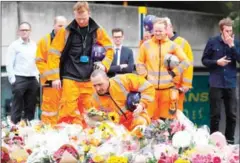  ?? ODD ANDERSEN/AFP ?? Constructi­on workers lay flowers at a pedestrian crossing on the south side of London Bridge, close to Borough Market, in London yesterday.