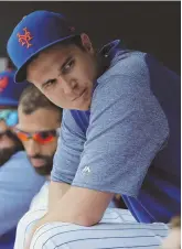  ?? AP PHoto ?? ABLE TO RELAX: Jacob deGrom sits in the dugout during the eighth inning of the Mets’ 8-0 rout of the Reds yesterday in New York.