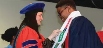  ??  ?? AUN President, Dr. Dawn Dekle, presents an induction sash to a student