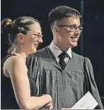  ??  ?? École François Buote teacher Rosalyn Abbott presents an award to Jacob Gagné, who was also the class valedictor­ian, during graduation ceremonies June 22.