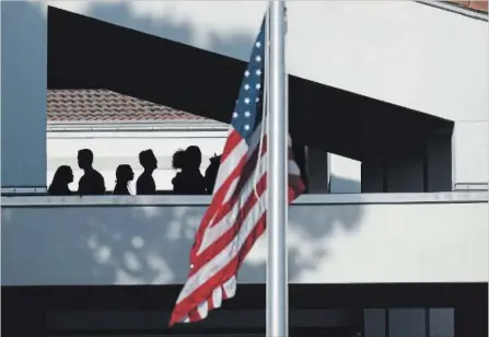  ?? MATT MCCLAIN MATT MCCLAIN ?? A flag flies at half-staff as students return to Marjory Stoneman Douglas High School in Parkland, Fla.