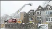  ?? NEWS-HERALD FILE ?? Firefighte­rs on scene March 14 after an early morning fire at the Willoughby­Eastlake Board of Education building.